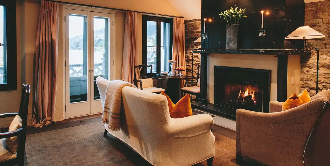 Don’t Miss These 8 Spectacular Luxury Hotels in New Zealand, Cozy Lounge by the Fire